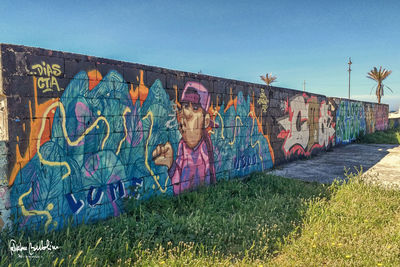 Graffiti on wall against clear sky