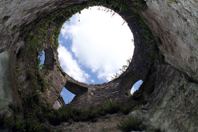 Low angle view of ruined building against sky