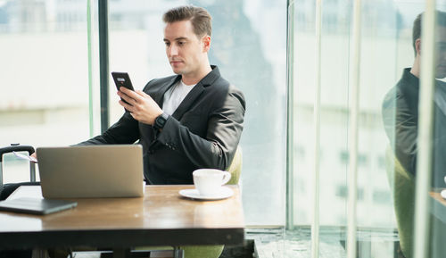 Man using mobile phone at table