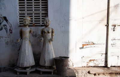Statues against wall