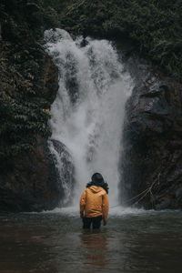 Rear view of waterfall in sea