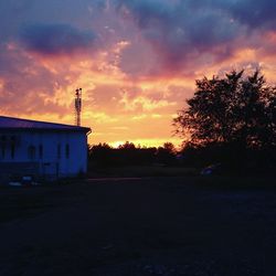 Silhouette of building against sky during sunset