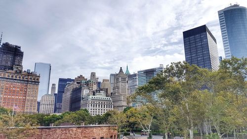 View of skyscrapers against cloudy sky