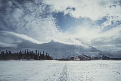 Scenic view of snow covered mountains against sky