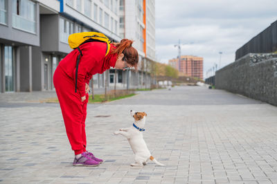 Woman with dog on footpath