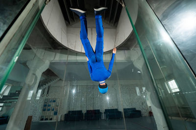 Low angle view of man walking on escalator