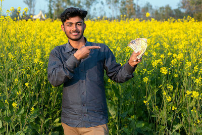 Portrait of man standing in field