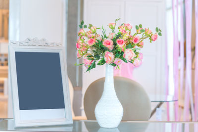 Close-up of flower vase on table at home