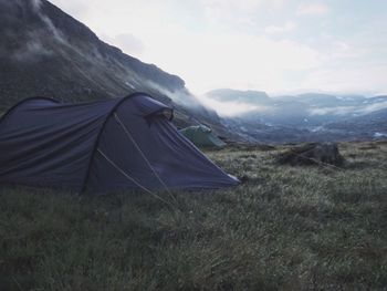 Tent on field against sky