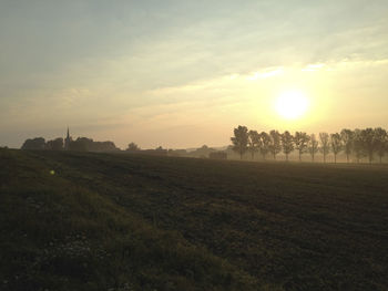 Scenic view of field against sky during sunset