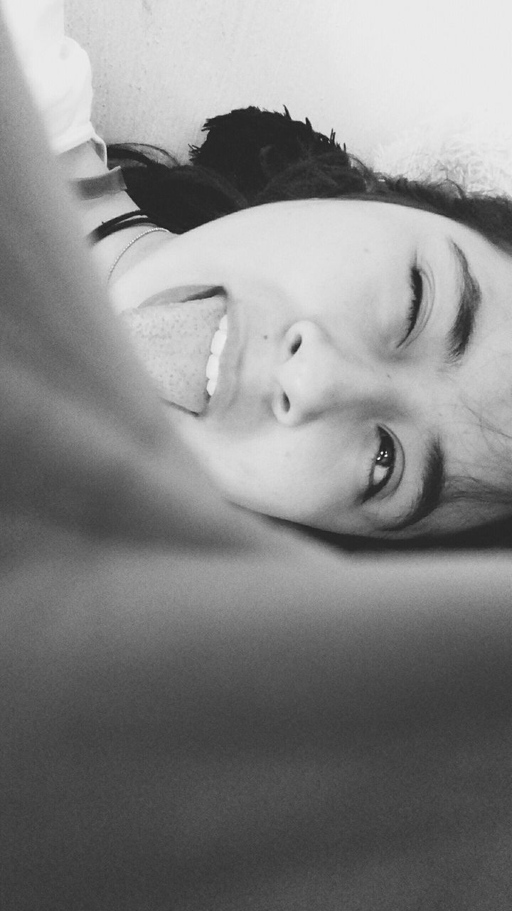 CLOSE-UP PORTRAIT OF A BOY LYING ON BED