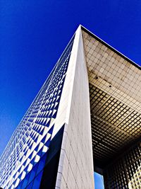 Low angle view of modern building against clear blue sky