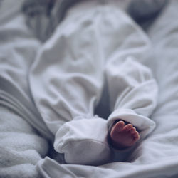 Low section of person lying on bed