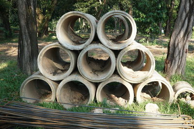 Stack of tree trunk in field