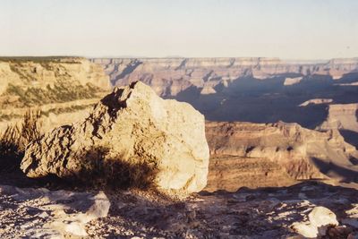 Rock formations on landscape against sky