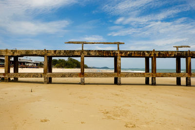 Lifeguard hut on beach against sky
