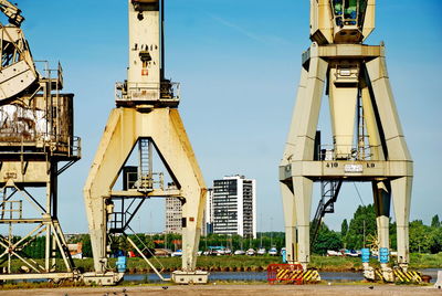 Low angle view of crane against sky