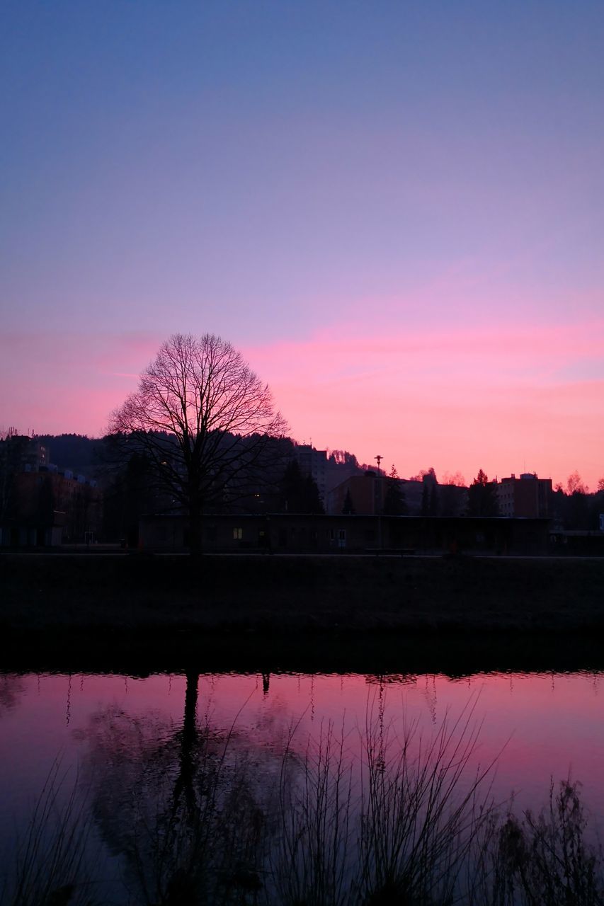 sunset, reflection, tree, silhouette, sky, beauty in nature, scenics, nature, no people, tranquil scene, dusk, tranquility, water, outdoors, lake, bare tree, built structure, building exterior, night, architecture