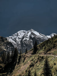 Scenic view of snowcapped mountains against clear sky