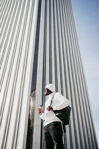 Low angle view of man standing against built structure