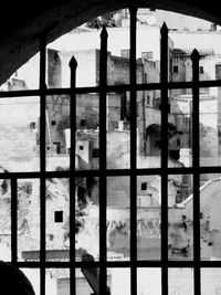 Buildings seen through metal window