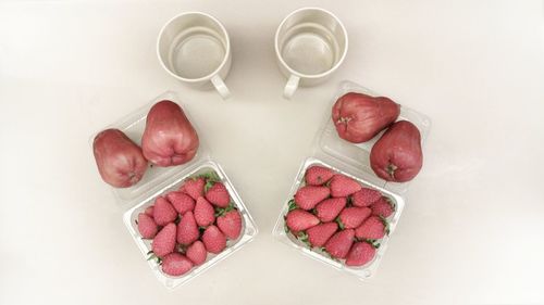 High angle view of fruits and white on table