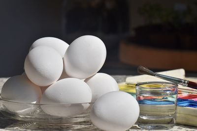 Close-up of eggs in glass container on table