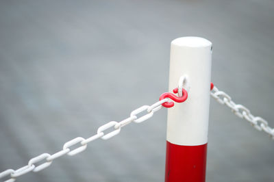 Close-up of chain hanging from bollard