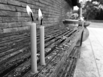 Close-up of lit candles on leaf