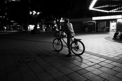 Man riding bicycle on street in city