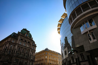 Low angle view of buildings against blue sky