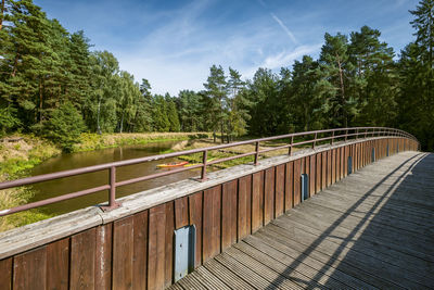 A footbridge with a wooden balustrade over the beautiful and transparent mala panew river. 