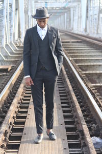 Man standing on railroad track