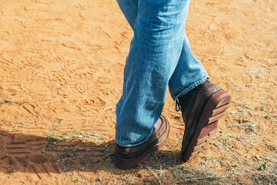 Low section of man standing on ground