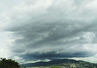 Scenic view of mountains against cloudy sky