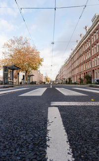 Surface level of road against sky in city