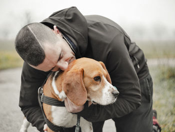 Man embracing dog