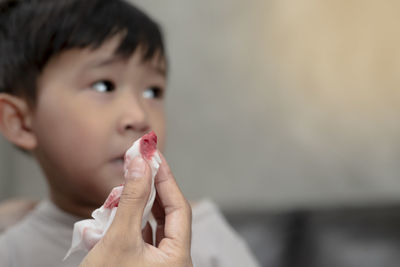 Close-up portrait of boy holding hands