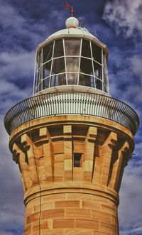 Low angle view of building against cloudy sky