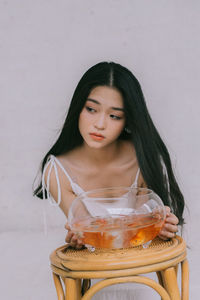 Teenage girl holding fish bowl