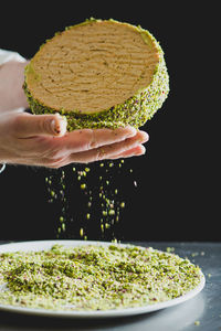 Close-up of chef's hands making cake