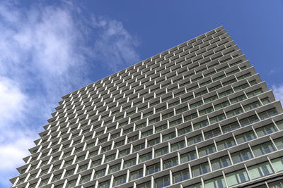 Low angle view of modern building against blue sky