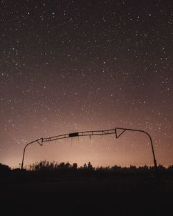 Scenic view of silhouette field against sky at night