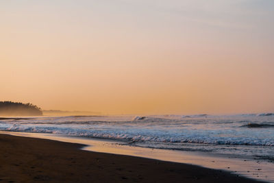 Scenic view of sea against clear sky during sunrise