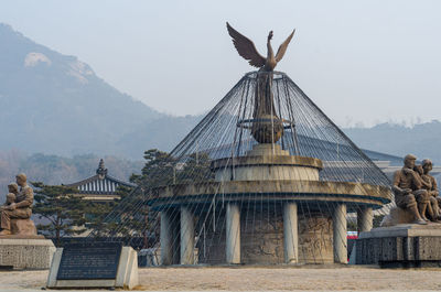 Statue of historic building against sky