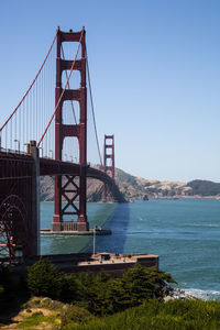 Golden gate bridge over sea against sky