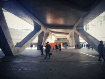 People walking on bridge in city