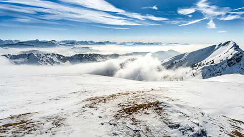 Scenic view of snow covered mountains against sky