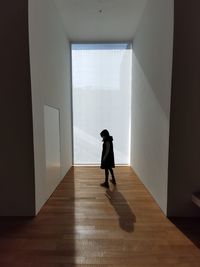 Rear view of woman walking on wall