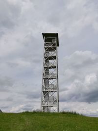 Low angle view of built structure on field against sky